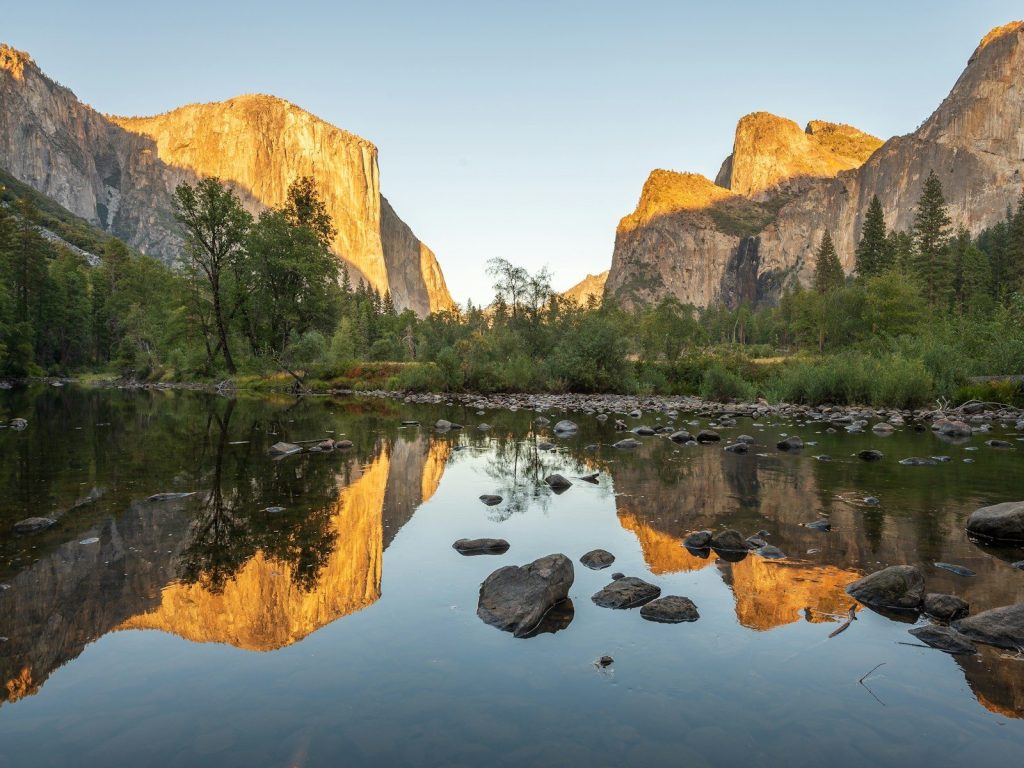 a body of water with rocks and trees around it