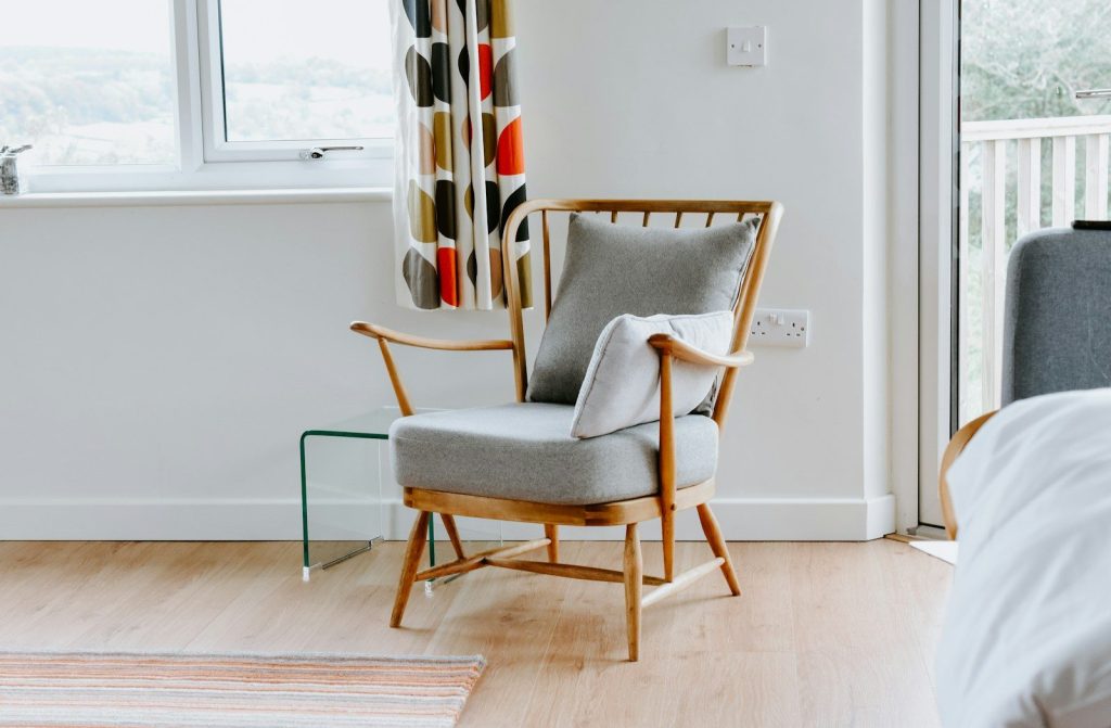 a living room with a chair and a window