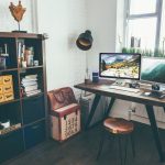 two flat screen monitor turned on near organizer rack inside the room