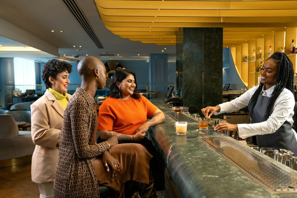a group of people standing around a bar
