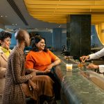 a group of people standing around a bar