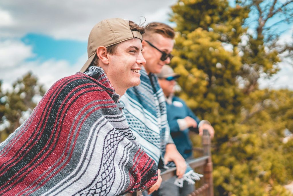 woman in red white and blue tribal print shirt wearing brown cap