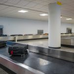 Luggage on a conveyor belt at an airport baggage claim.