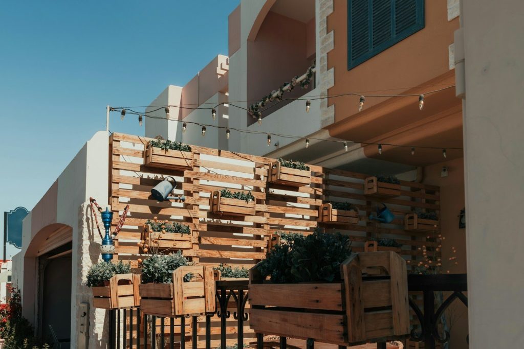 A group of wooden chairs sitting on top of a sidewalk