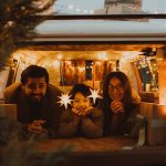 Family in camper van decorated for christmas