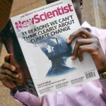 man reading New Scientist book