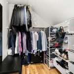 A walk in closet filled with lots of clothes